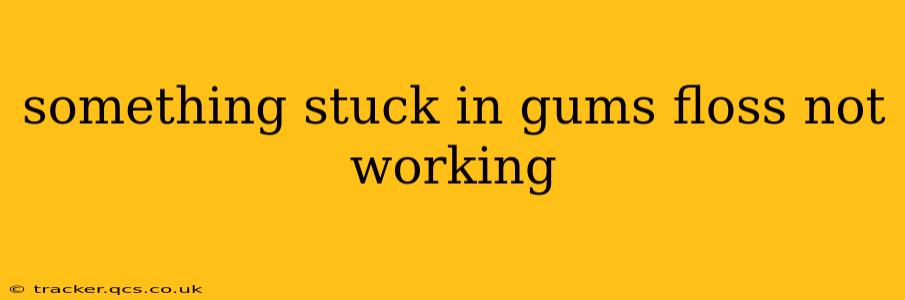 something stuck in gums floss not working